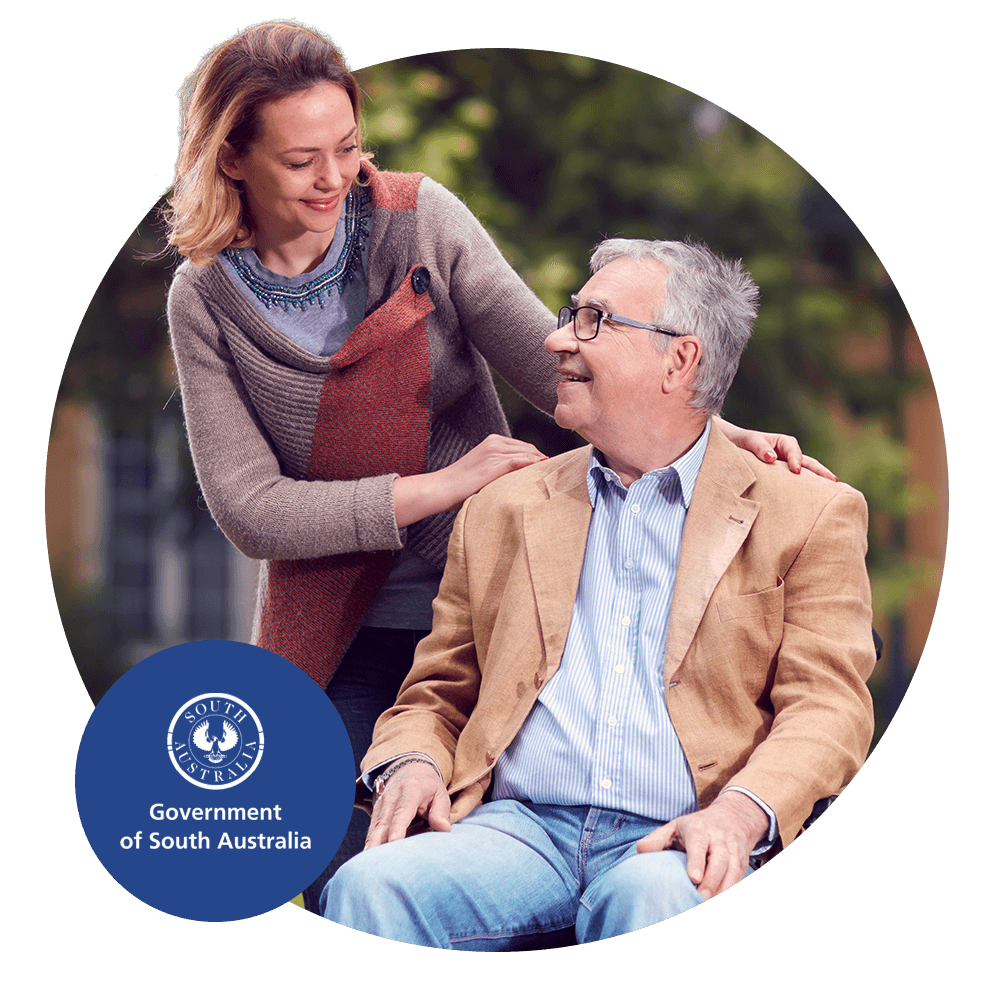 A carer talking to a disabled person in a wheelchair