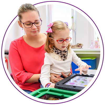 Mother and child playing on a tablet together and smiling