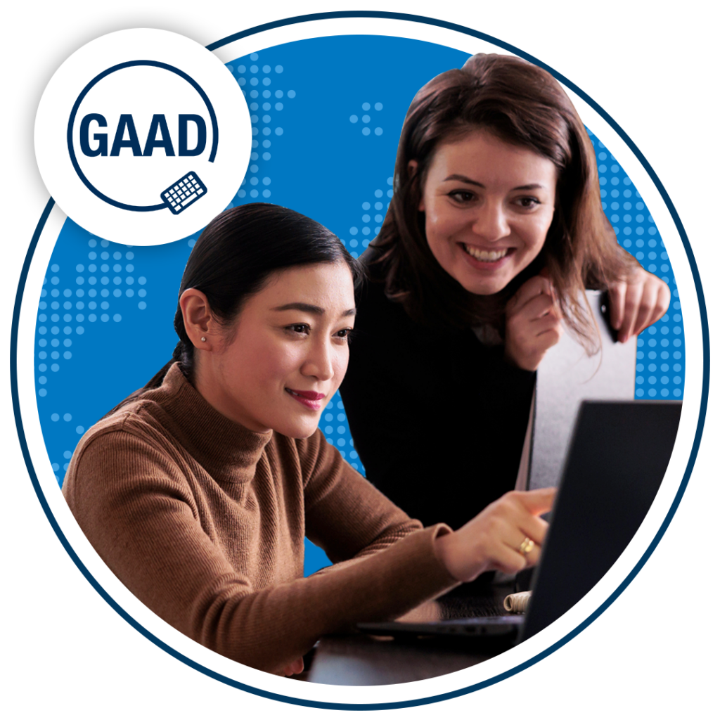 Two people smiling at computer. GAAD logo