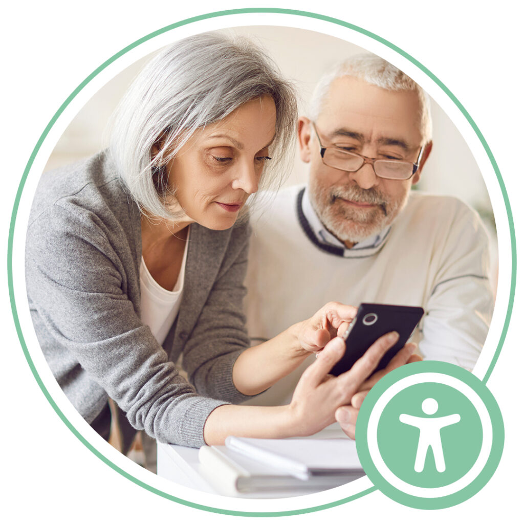 two elderly people looking at mobile phone screen