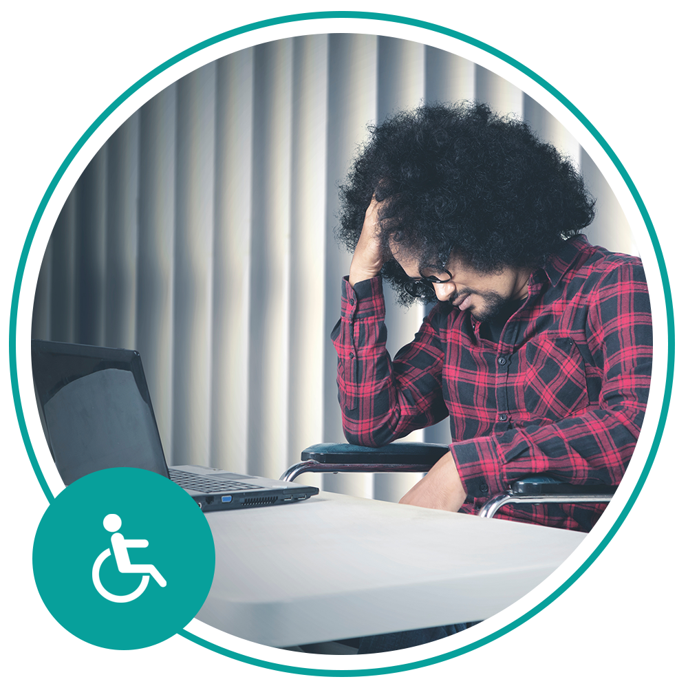 man sitting at desk looking sad