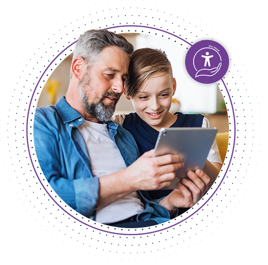 Image of a man and young boy looking at a tablet with a purple Accessibility to Me icon at the top right