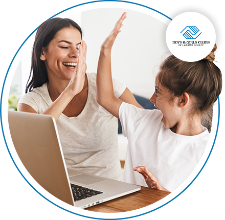 Image of a woman and little girl high-fiving while they look at a computer.