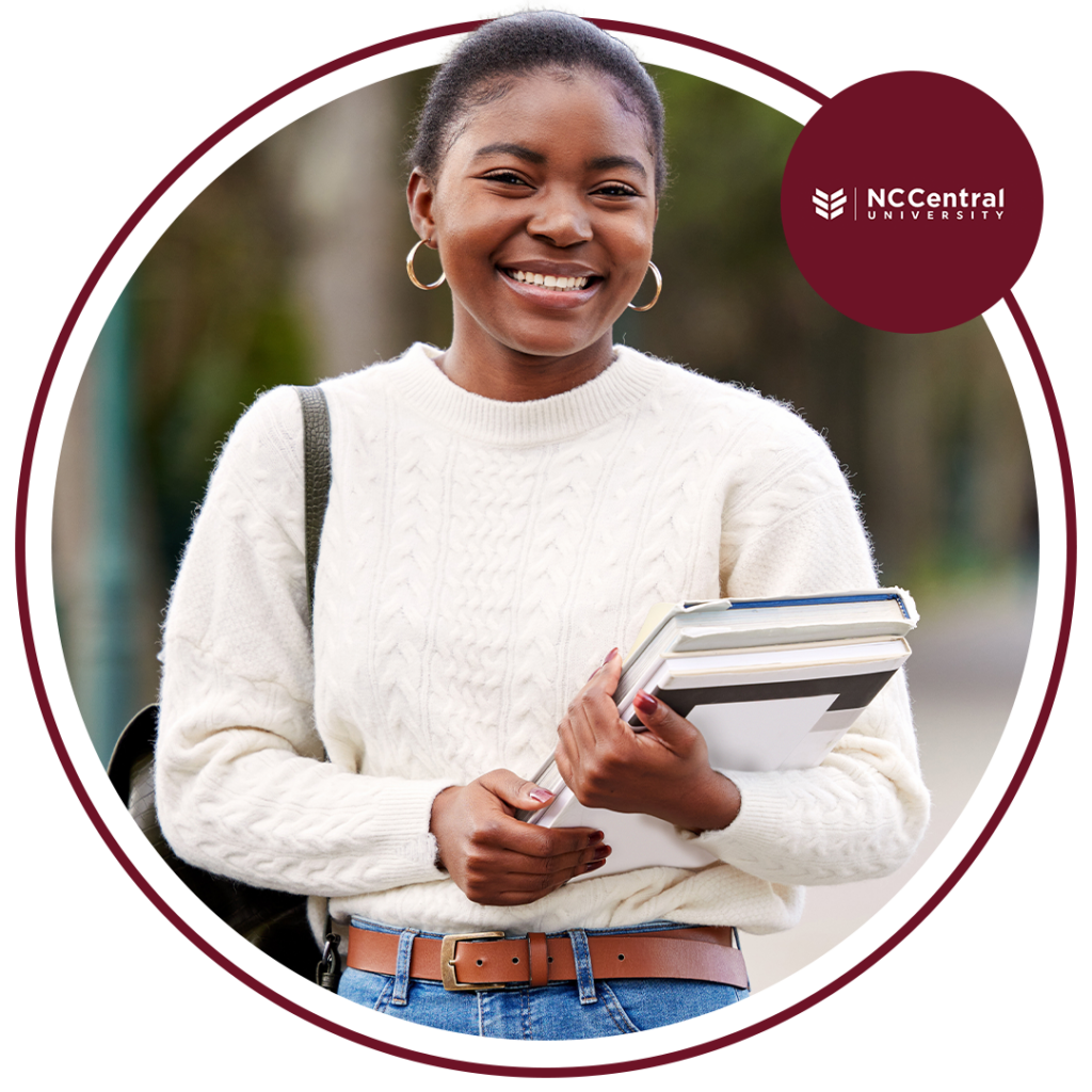 Image of a young black woman in a white sweater holding books with the NC Central University logo