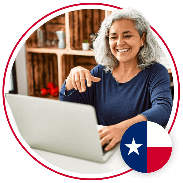 elderly woman sitting at laptop smiling