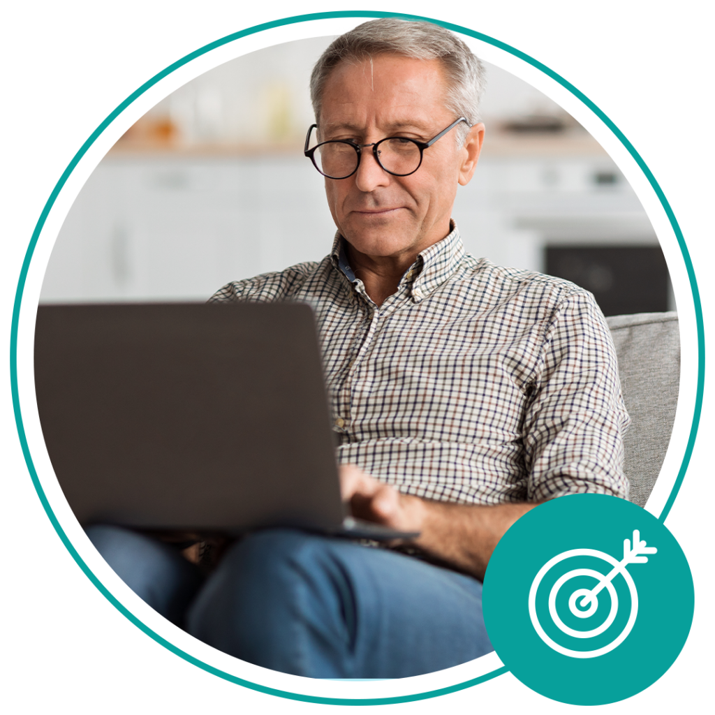 elderly man with glasses using laptop