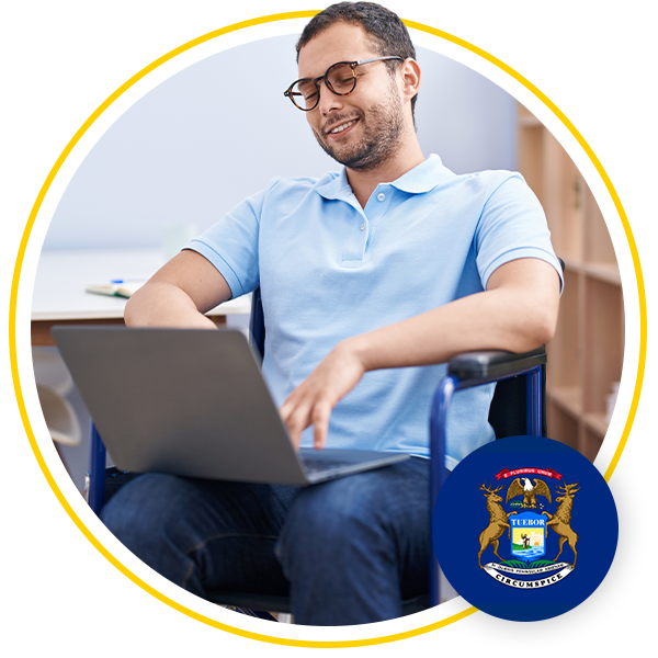 man sitting in chair using laptop