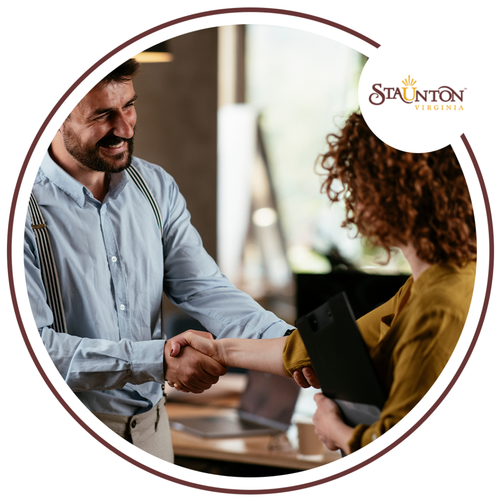 Image of a man and woman shaking hands in an office setting