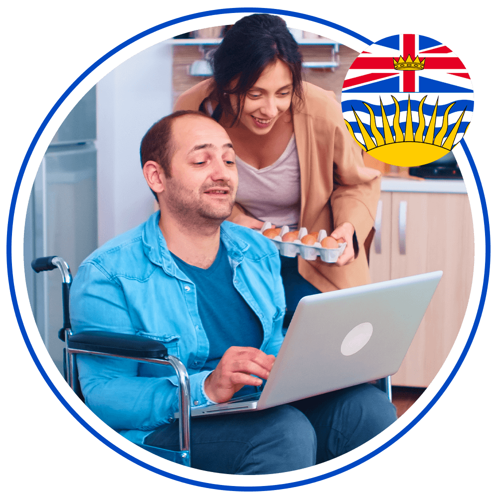man sitting in wheelchair using a laptop