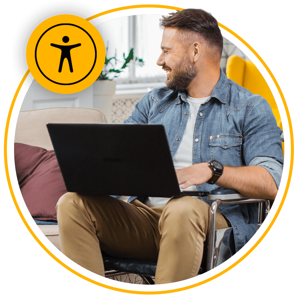 man sitting in wheelchair using laptop