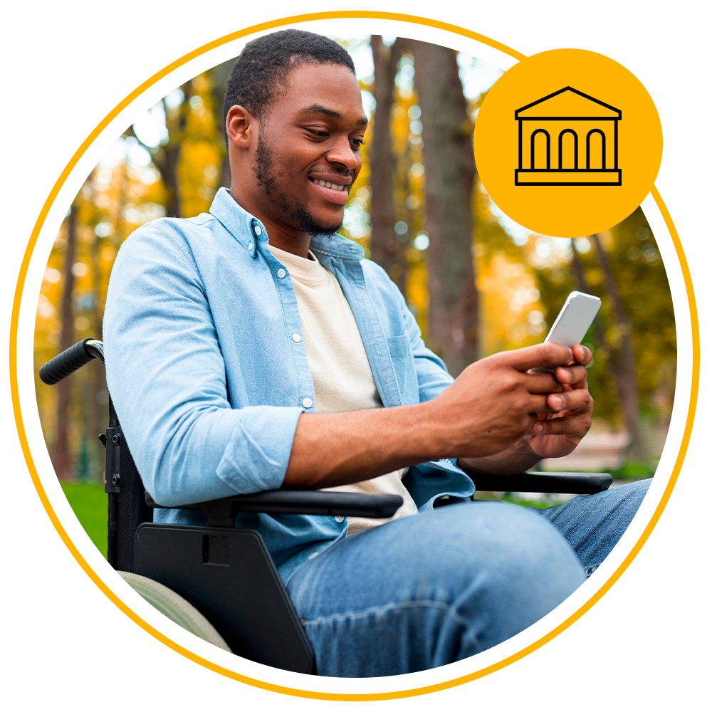 man sitting in wheelchair using mobile