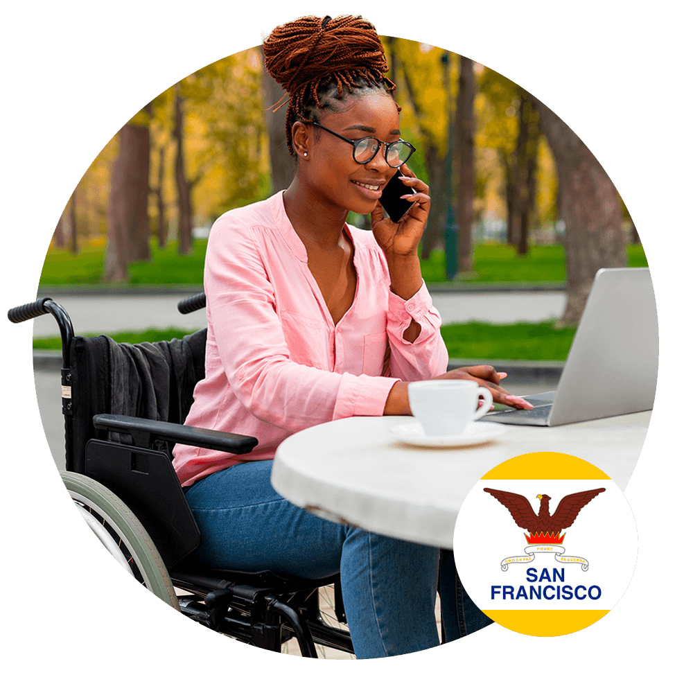 woman sitting in a wheelchair using laptop