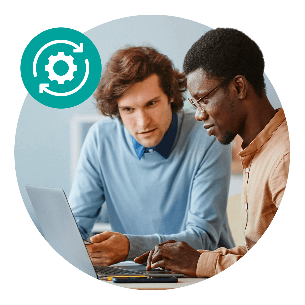 two men sharing laptop monitor