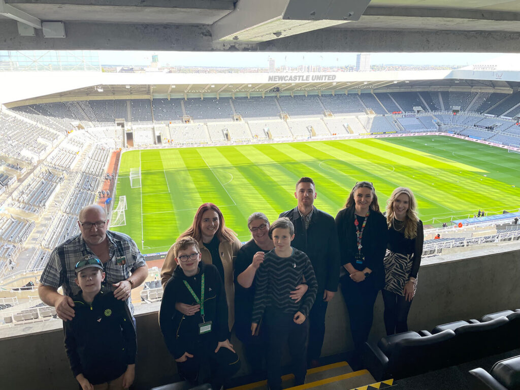 group photo of everyone in front of the pitch