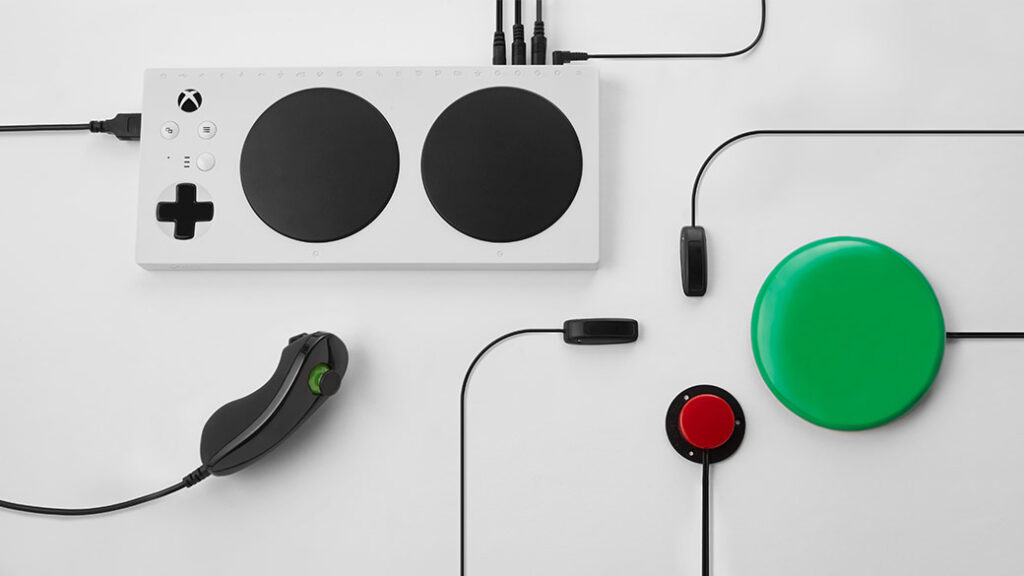 A picture of the Xbox Adaptive Controller with multiple compatible attachments in shot.