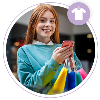 woman smiling carrying shopping bags and on her phone