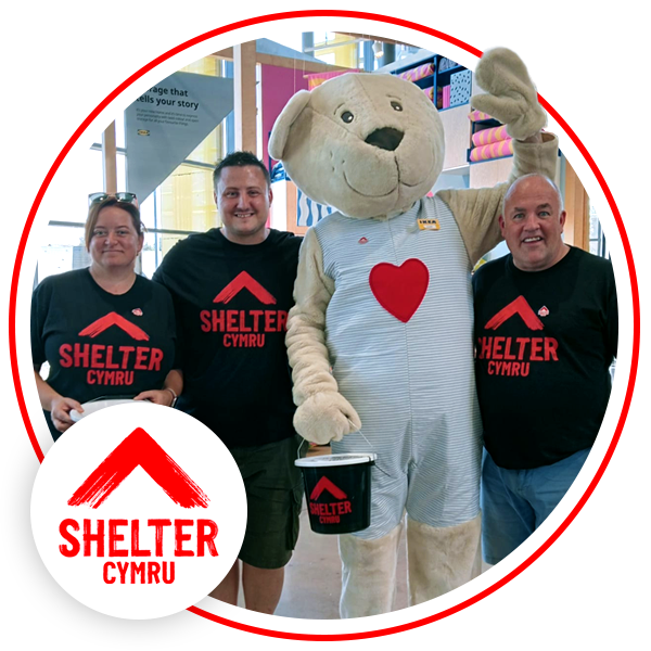 Three Shelter Volunteers smiling with a bear mascot