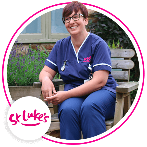 Image shows St Lukes employee sitting on a bench smiling.