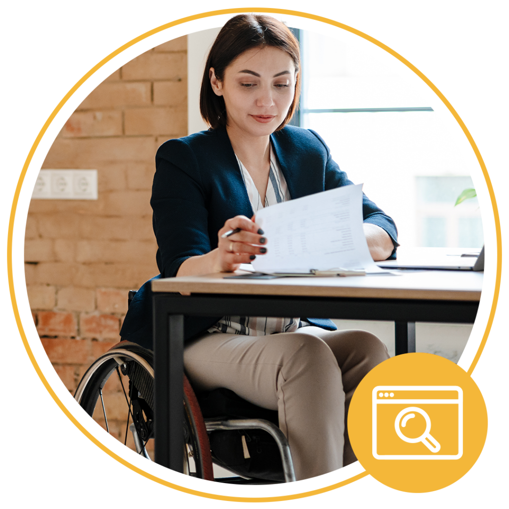 girl sitting in wheelchair looking at paper