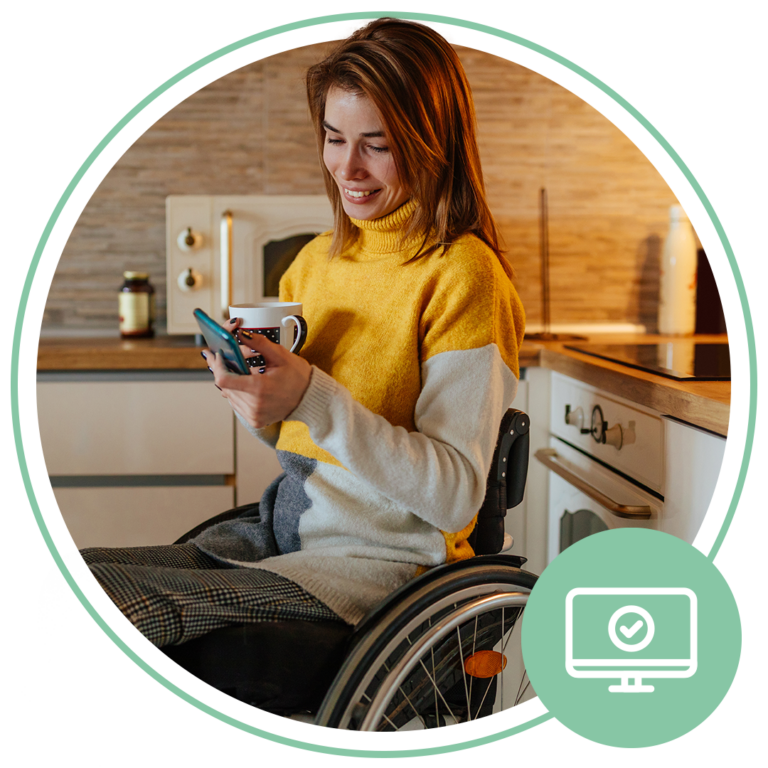 woman sitting in wheelchair drinking coffee and looking at mobile phone