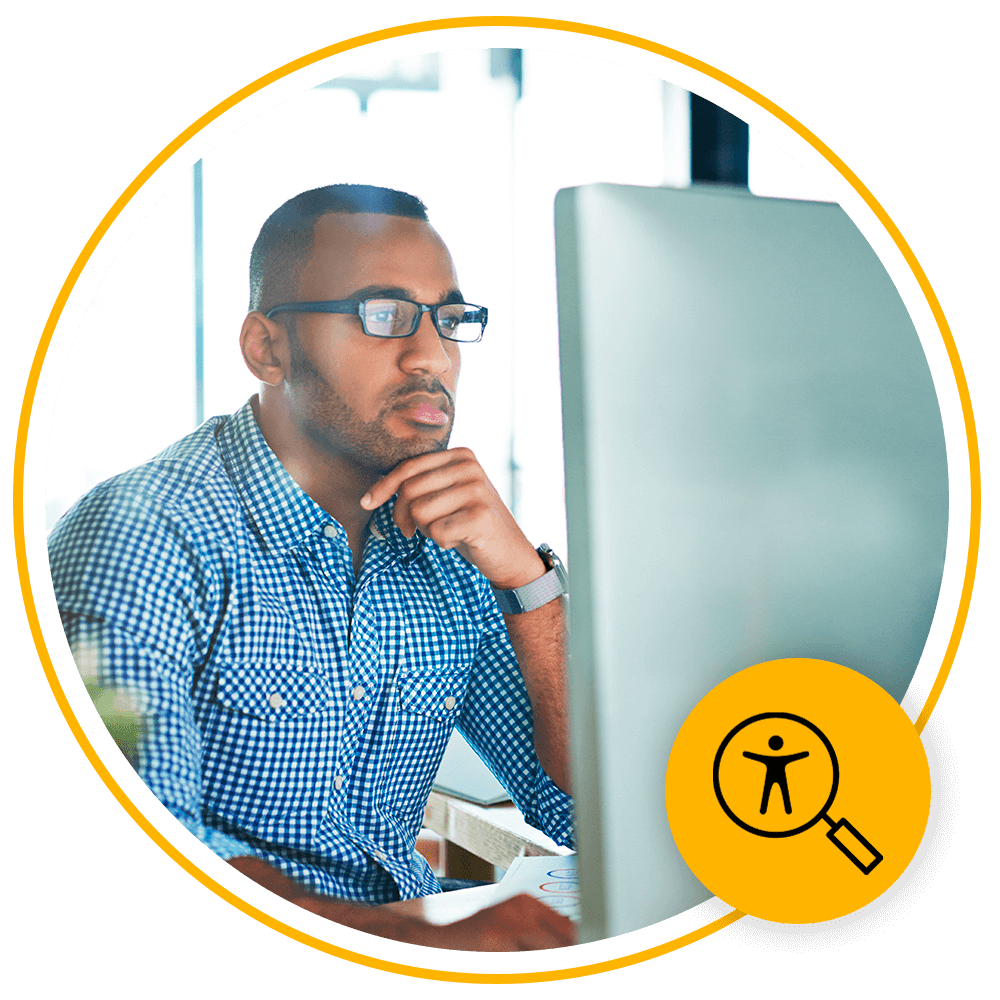 man with glasses using computer