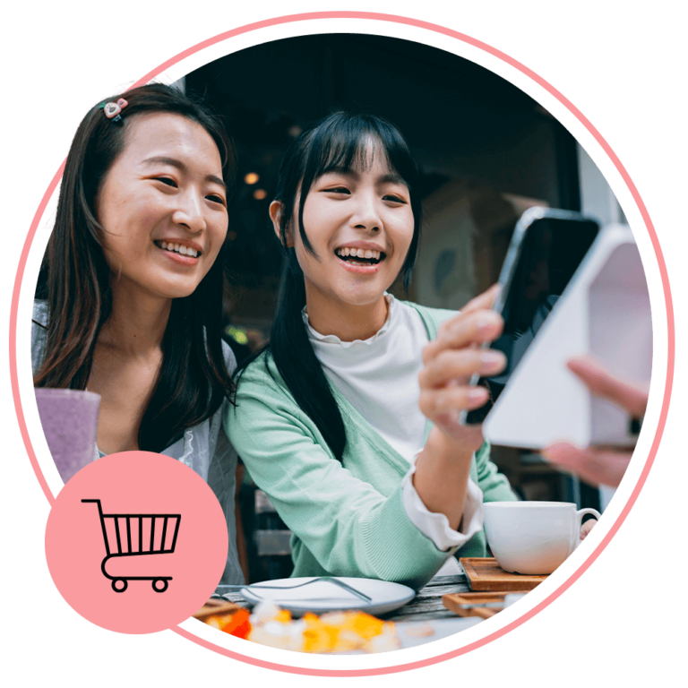 Two women sharing notes on an ipad