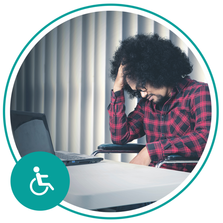 man sitting at desk looking sad
