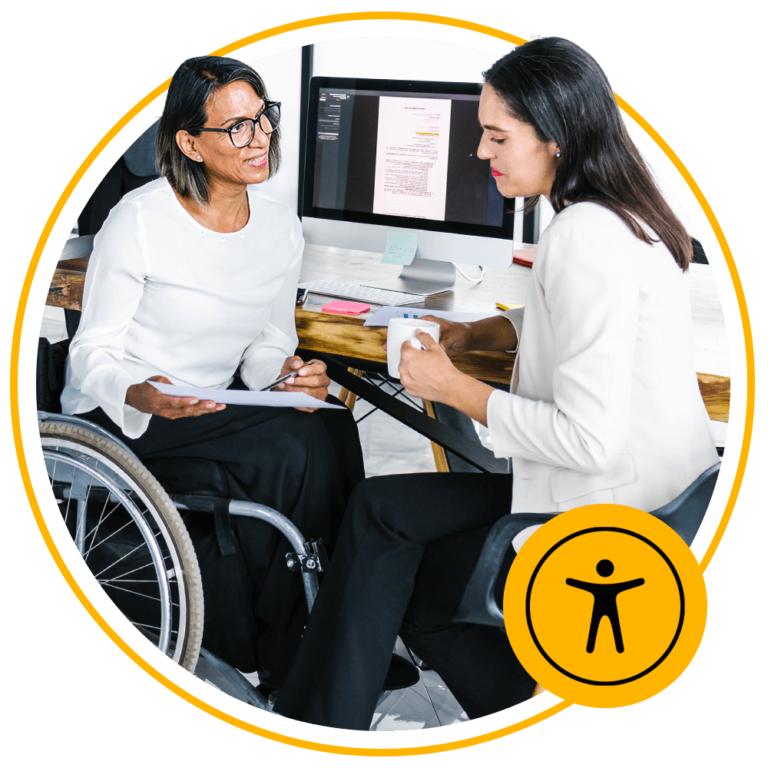 woman sitting in wheelchair talking to another woman