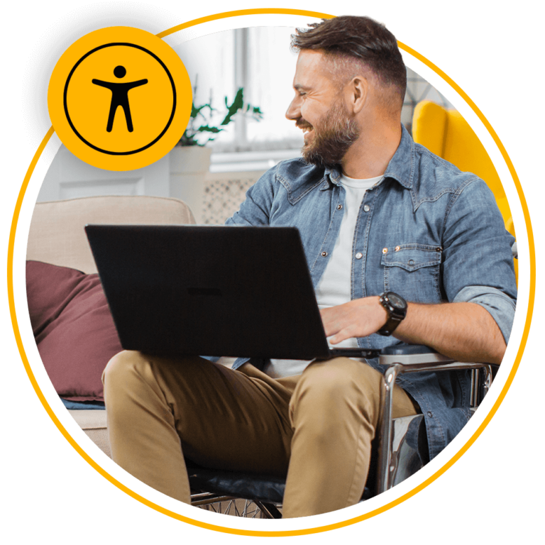 man sitting in wheelchair using laptop