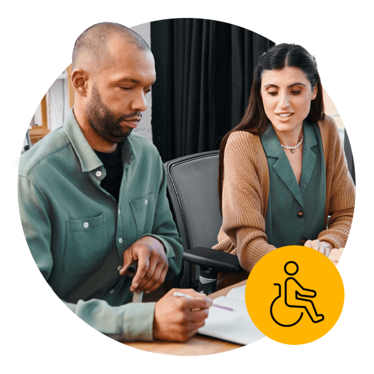 A disabled worker collaborating with a colleague in an office