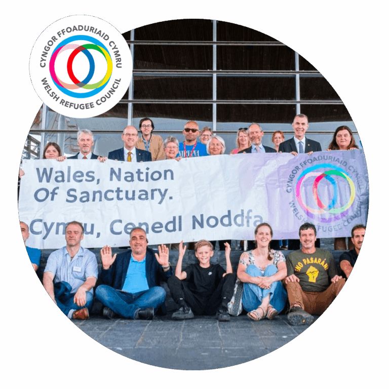 Image of Welsh Refugee Council holding banner