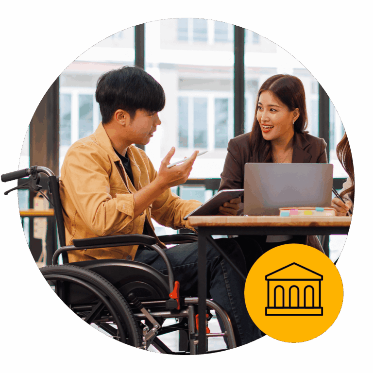 A man sitting in a wheelchair and speaking to a woman