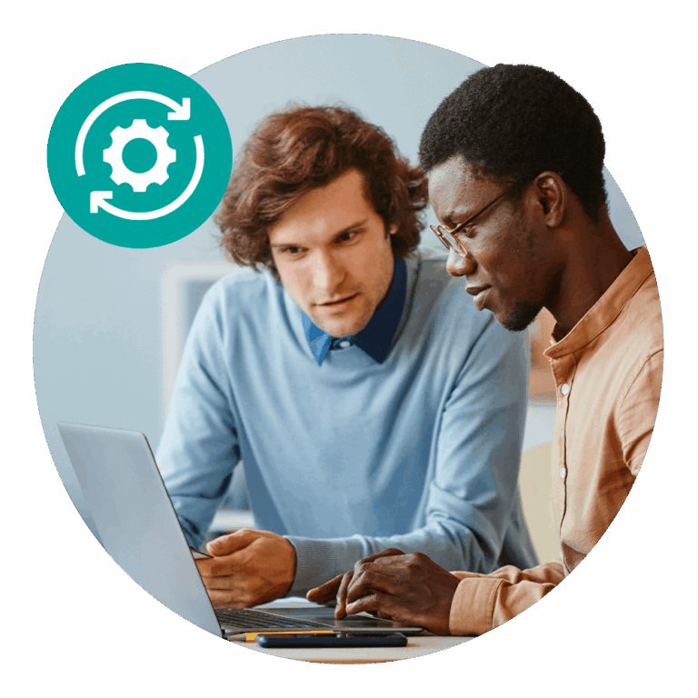 two men sharing laptop monitor