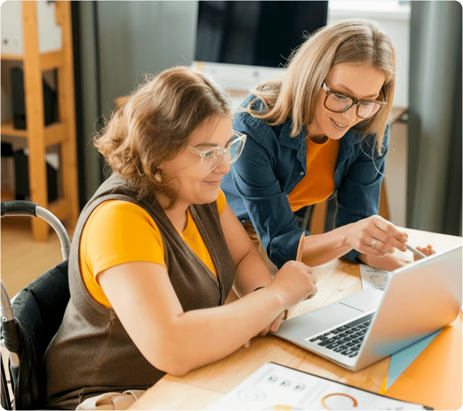 2 females colleagues working together on a laptop
