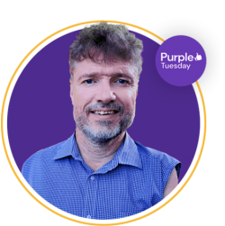 mike adams headshot, smiling into the camera. Purple Tuesday logo is to his right